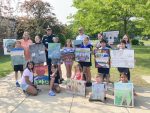 Winning submissions held by the young artists (and Denise Johnson, Chief Newell, Chief Achilles,  Ryan Donovan and Marianna Sorensen)