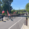 The procession included Town officials, scouts, and the Trottier Marching band, and was accompanied by a crowd of residents