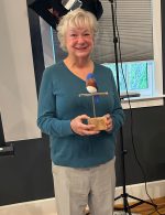 Joyce Greenleaf holds the hand-carved wooden bluebird as part of her recognition for "outstanding leadership in environmental conservation" (contributed photo)